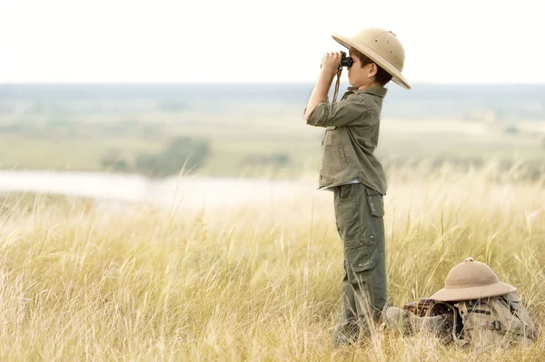 Niño con turista mirando a través de binoculares en la distancia en el precipicio —  Fotos de Stock