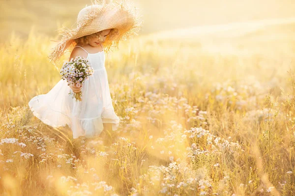 Klein meisje met een boeket wilde bloemen — Stockfoto