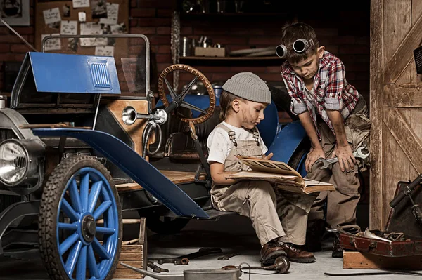 Meninos-mecânico com ferramentas no carro na garagem — Fotografia de Stock