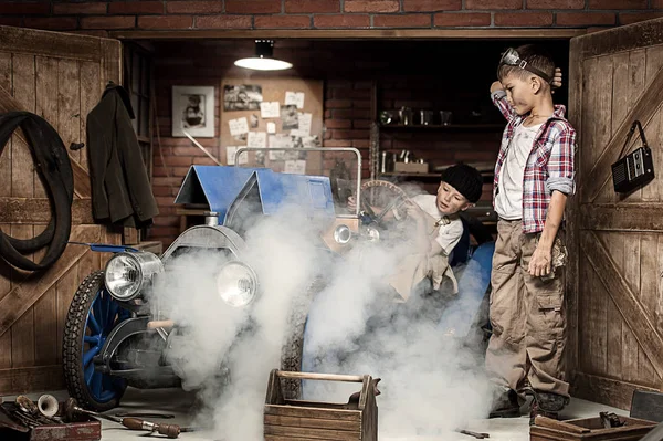 Boys-mechanic with tools in the car in the garage — Stock Photo, Image