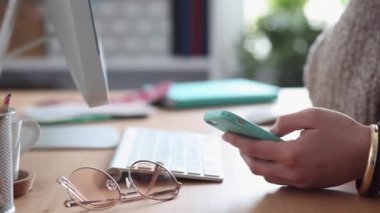 Young Woman Procrastinates Scrolling her Smartphone