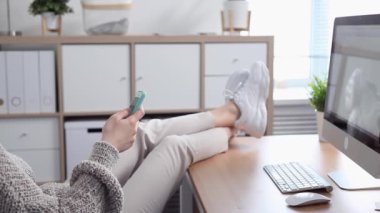 Young Woman Procrastinates Scrolling her Smartphone