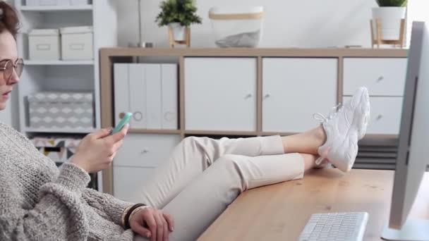 Young Woman Procrastinates Scrolling her Smartphone — Stockvideo