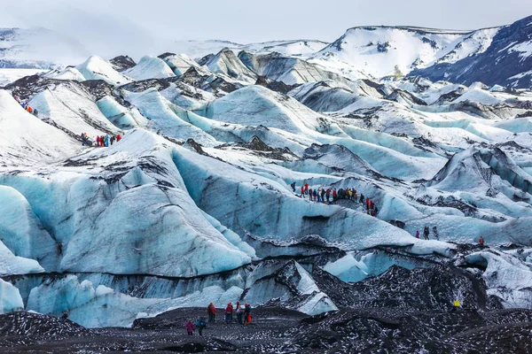 Özel Rehberi ve grup Solheimajokull, İzlanda, buzul üzerinde yürüyen uzun yürüyüşe çıkan kimse