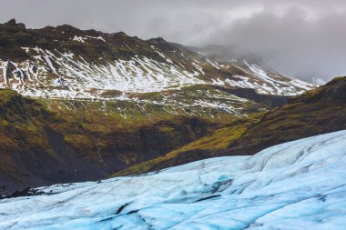 Dağ geçmişi bulutlu s altında olan buzul ön plan