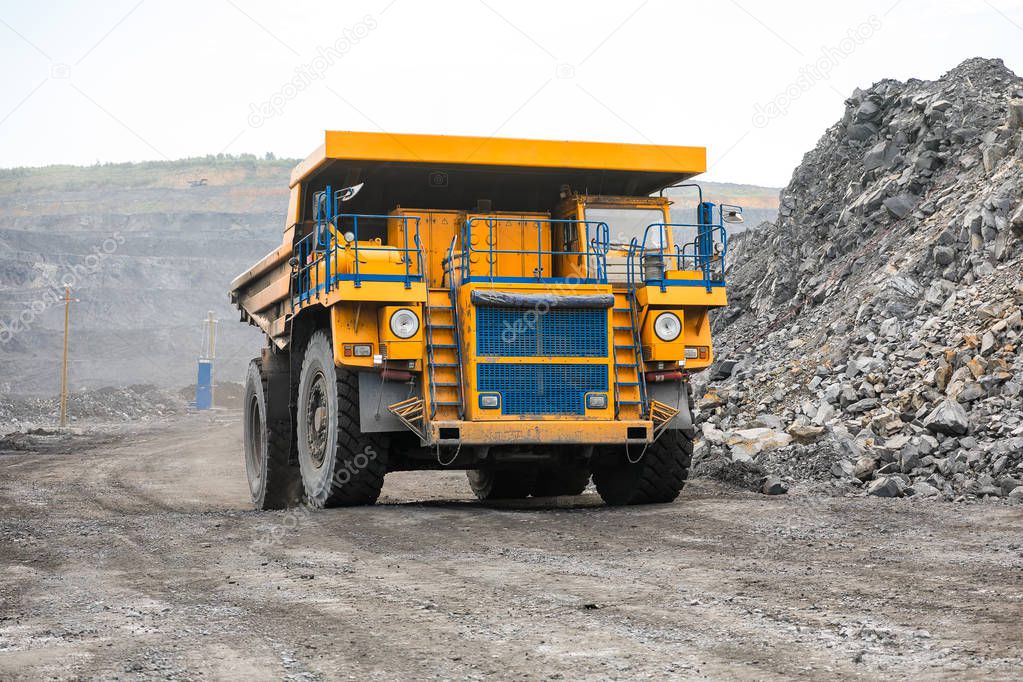 Large quarry dump truck. Loading the rock in dumper. Loading coal into body truck. Production useful minerals. Mining truck mining machinery, to transport coal from open-pit as the coal production.