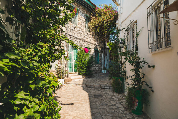 Beautiful Streets of old Marmaris. Narrow streets with stairs among the houses from old stone, green plants and flowers in the old town of resort of in Turkey. Popular destination