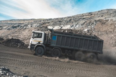 Large quarry dump truck. Loading the rock in dumper. Loading coal into body truck. Production useful minerals. Mining truck mining machinery, to transport coal from open-pit as the Coal Production clipart