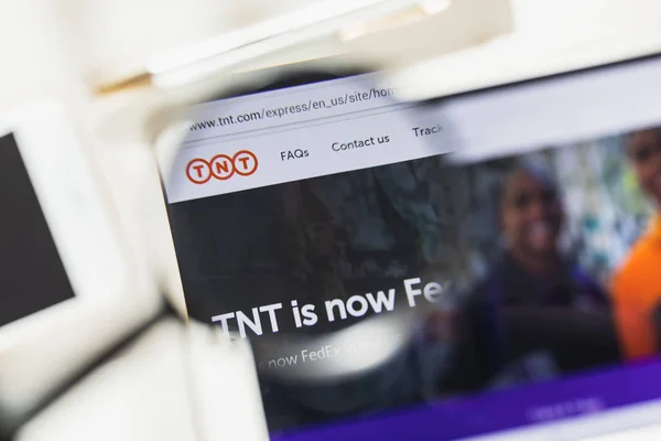 Washington, D.C., EE.UU. - 27 de febrero de 2019: página web oficial de TNT Express bajo lupa. Concepto Moodys Corporation logotipo visible en el teléfono inteligente, pantalla de la tableta , — Foto de Stock