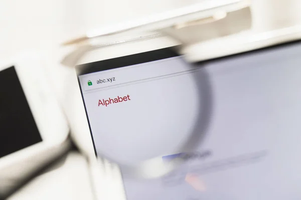 Los Angeles, California, Usa - 27 februari 2019: homepage van de officiële website van alfabet Inc. onder vergrootglas. Concept alfabet Inc. logo zichtbaar op smartphone, Tablet PC-scherm, — Stockfoto