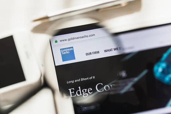 New York, USA - 4 March 2019: Goldman Sachs Group official website homepage under magnifying glass. Goldman Sachs Group logo visible on smartphone, tablet screen — Stock Photo, Image