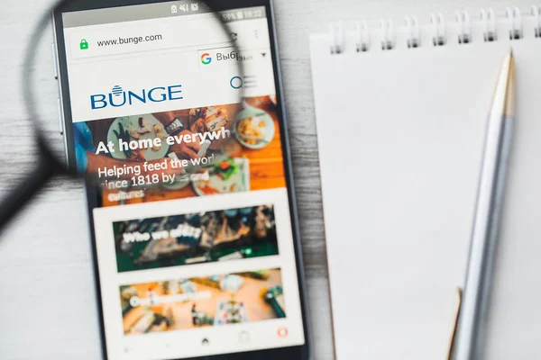Los Ángeles, California, EE.UU. - 3 de abril de 2019: Bunge Limited food company official website homepage under magnifying glass. Concept Bunge Limited logotipo de la compañía de alimentos visible en el teléfono inteligente, pantalla de la tableta — Foto de Stock