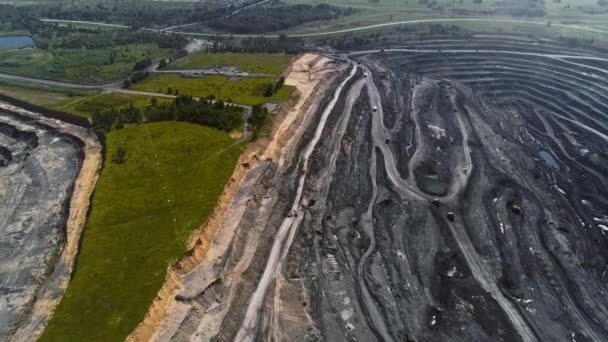 Panorama aerial view shot open pit mine coal mining, dumpers, quarrying extractive industry stripping work. Big Yellow Mining Trucks. View from drone at opencast mining with lots of machinery trucks — Stock Video