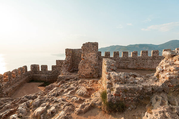 Panorama ancient Greco Roman city. Ruins of an ancient fortress, Alanya, Turkey. Ruined ancient military fort in Europe. Alanya is popular tourist destination in Turkey