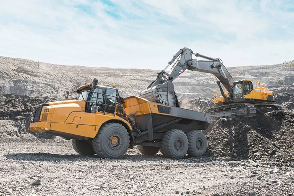 Grande camião de descarga de pedreiras. A carregar a pedra no despejo. A carregar carvão no camião do corpo. Produção minerais úteis. Máquinas de mineração de caminhões de mineração, para transportar carvão de escavadeira a céu aberto — Fotografia de Stock