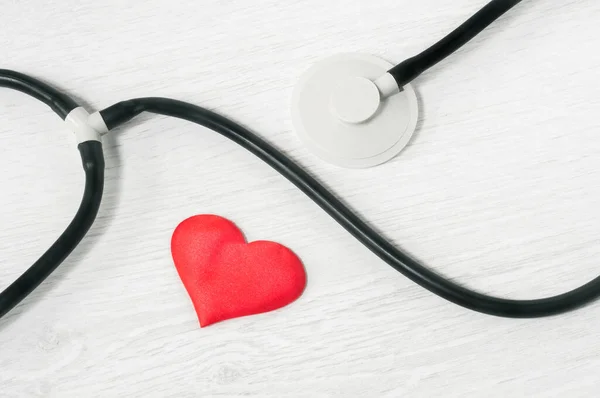 stethoscope and heart on a light background top view. Healthcare concept