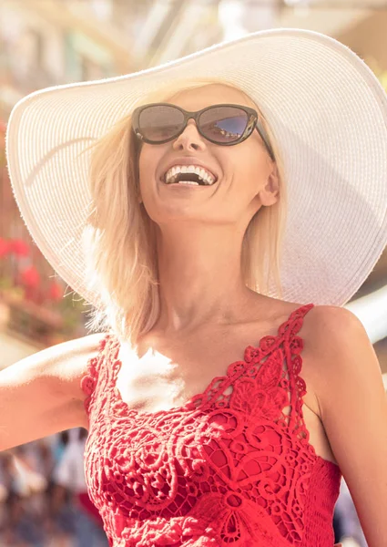 Happy female wears summer hat and fashionable sunglasses smiling. Summer sunny day.