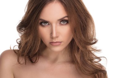 Uzun dalgalı saçlı Genç beyaz esmer kadın güzellik portresi. Kız beyaz stüdyo arka plan üzerinde poz kamera bakıyor. Cilt bakım kavramı.