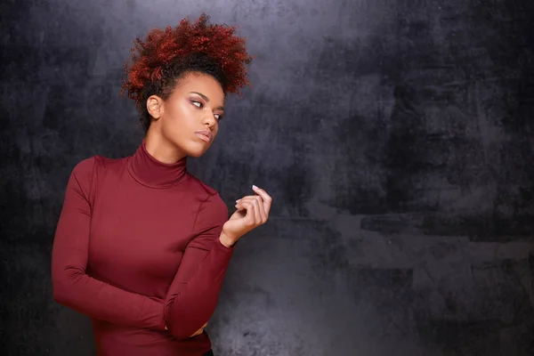 Studio fashion portrait of beautiful african american woman on dark background. Stylish autumn look .