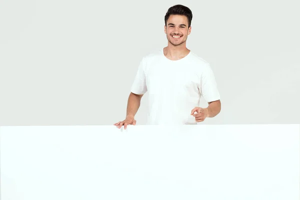 Knappe Jongen Poseren Met Lege Witte Banner Uithangbord Geïsoleerd Witte — Stockfoto