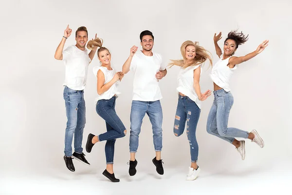 若者のグループ多民族魅力的な白いシャツを着て笑顔し 楽しんで 一緒にスタジオでジャンプ — ストック写真