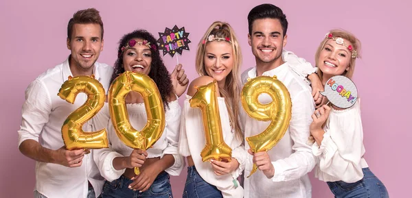 Group of beautiful young people celebrating new year 2019.