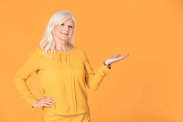 Attrative Smiled Fashionable Senior Woman Posing Yellow Studio Background — Stok Foto