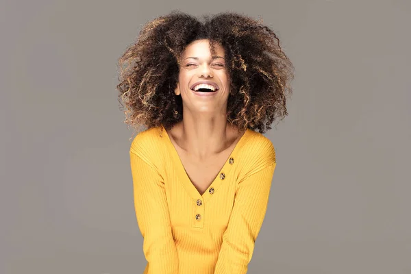 Happy african american woman smiling. Beautiful female half-length portrait. Young emotional afro woman. The human emotions, facial expression concept.