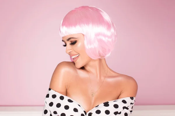 Pink bob short hairstyle. Beautiful woman in fashionable dress with black dots. Trendy haircuts.