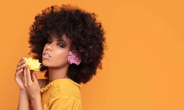 Skönhet afro kvinna med färska blommor. — Stockfoto