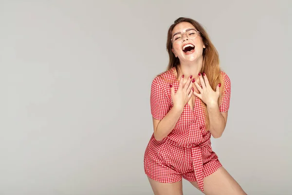 Ginger girl with freckles posing in studio, emotions.