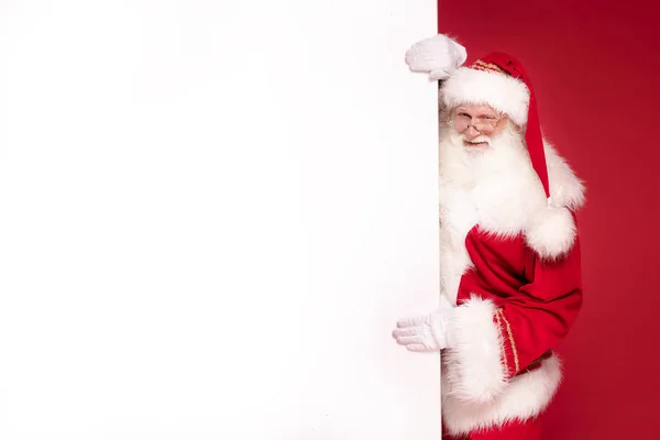 Real Santa Claus holding white empty board.