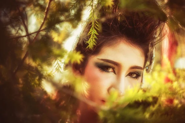 close up of asia beautiful young woman posing in forest