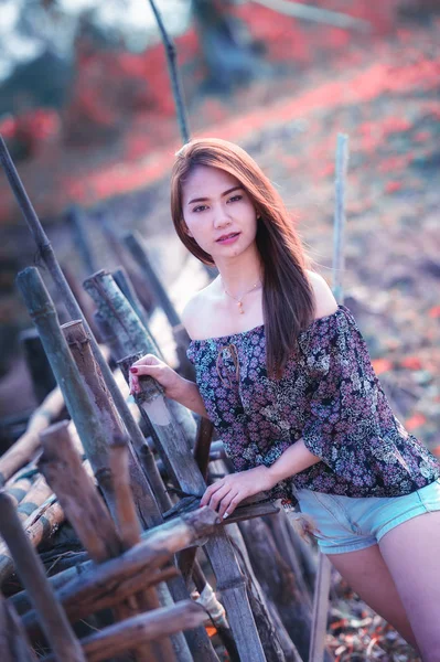 asia woman in Off  Shoulder shirt and short jeans standing on nature