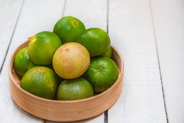 Beyaz ahşap sepetteki limon, malzeme gıda konsepti..