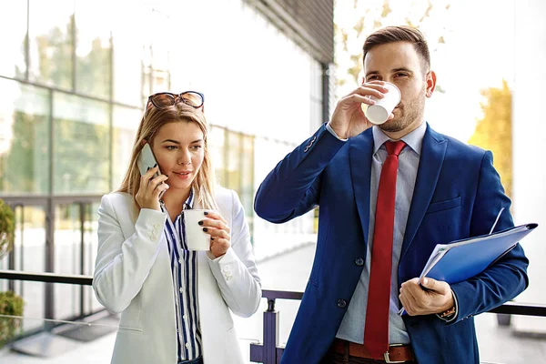 Genç iş adamları şirket bina ve yeni proje hakkında tartışmaya önünde rahatlatıcı.