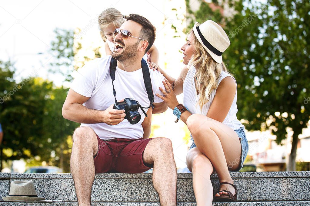 Young and happy family is enjoying traveling.