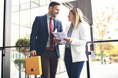 Genç iş adamları şirket bina ve yeni proje hakkında tartışmaya önünde rahatlatıcı.