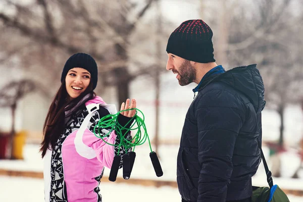 Young fit couple is exrcise on the snow.