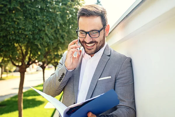 Young Businessman Using Mobile Phone Front Company Building Royalty Free Stock Photos