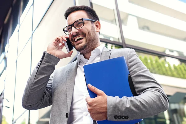 Young Businessman Using Mobile Phone Front Company Building Royalty Free Stock Photos