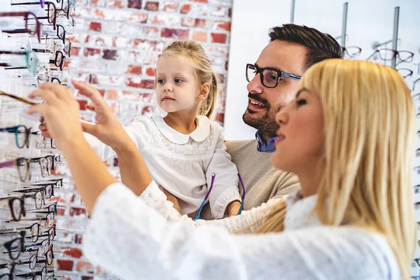 Happy Family Choosing Glasses Optics Store Stock Photo