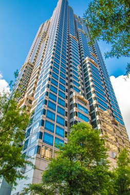 Atlanta, Ga / USA - 05: 30 20: Ağaçlar ve mavi gökyüzü ile şehir merkezinde parlak bir gökdelen