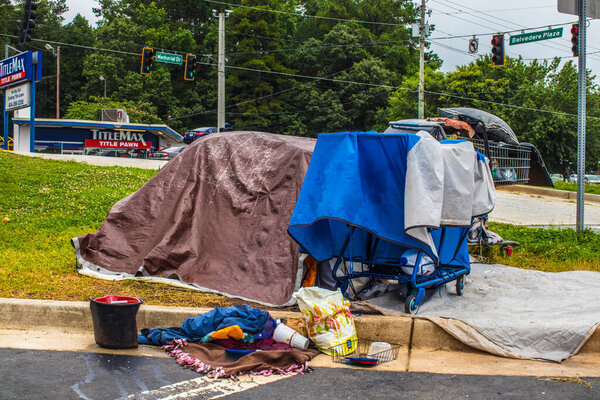 Dekalb County, Ga / USA - 07 07 20: View of homeless camp at the edge of a busy Kroger shopping center on Memorial Dr