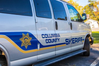 Appling, Ga / USA - 10 14 20: Columbia County Sheriff inmate transport van close up by county logo clipart