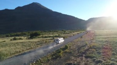 Hava dron sahne, bir toprak yol üzerinde ilerlemeye ve bir kamyonet ve karavan, Neuquen, Patagonia, Arjantin izleme kamera