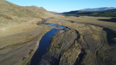 Bozkır ve Nahueve Nehri neuquen, Patagonya Arjantin hava dron sahne. Gün batımı, altın saat, arkadan. EPU Lauquen göller. Hareketli kamera iletir ve aşağı. Çam ekimi, ağaçlandırma.