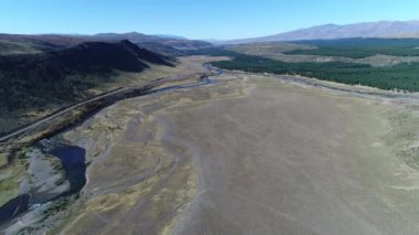 Estepa ve Nahueve Nehri Kuzey neuquen, Patagonya Arjantin hava dron sahne. Kamera hareketli güneşli günde iletir. ağaçlandırma, çam ekimi için ticari ahşap. Çakıl yol