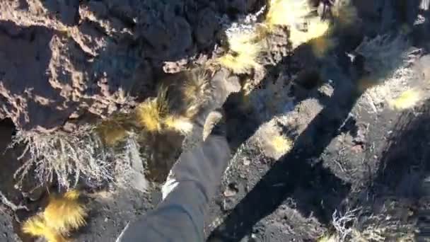 Stabilized Camera Ponting Feet Man Walking Black Small Lapillis Rocks — Stock Video