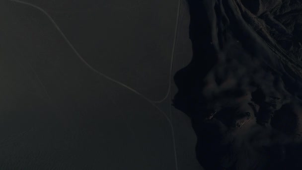 空中ドローン シーン Payunia 国立公園内の砂利道平面図です 暗い黒のアースは火山 Lapillis 岩から成っています シーンの右の溶岩のベッド Malargue アルゼンチンのメンドーサ — ストック動画